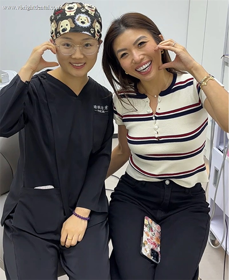 Smiling patient forming a heart shape with our dentist