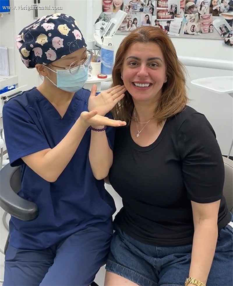 Patient showing off her new smile at the clinic