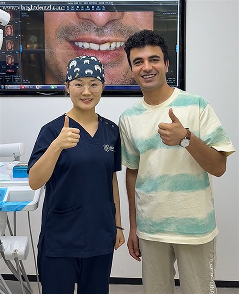 Happy patient giving a thumbs up with the VBright Dental team