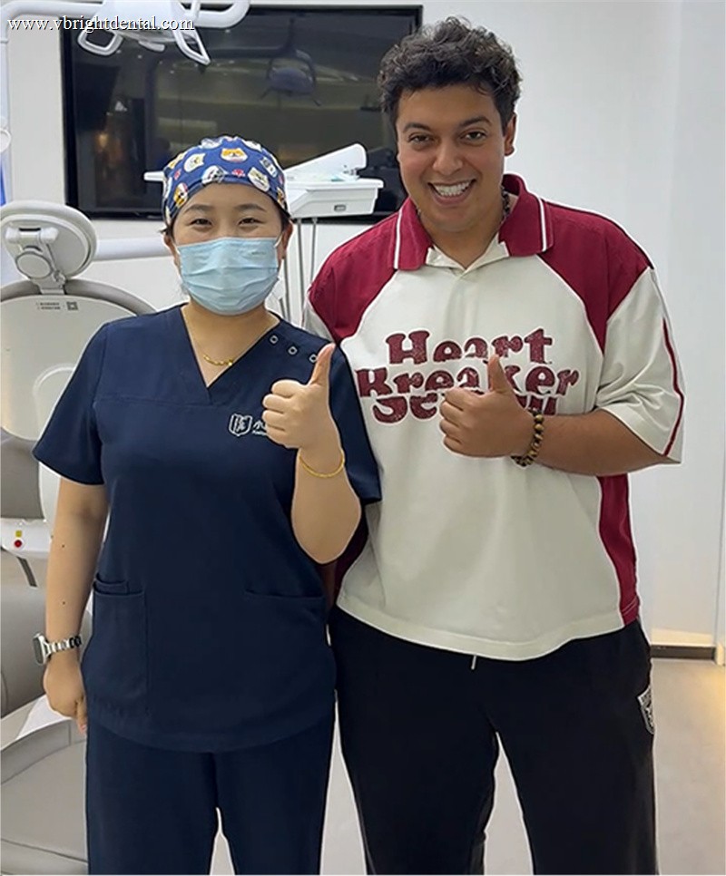 Patient giving a thumbs up with our dental team